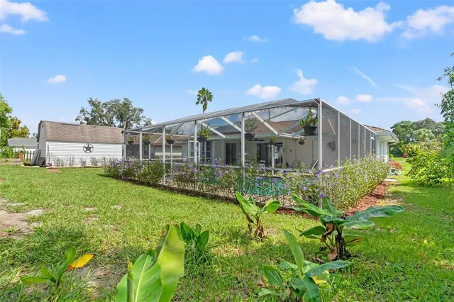 a view of a house with backyard and sitting area