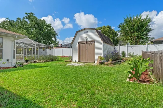 a view of a house with backyard and sitting area