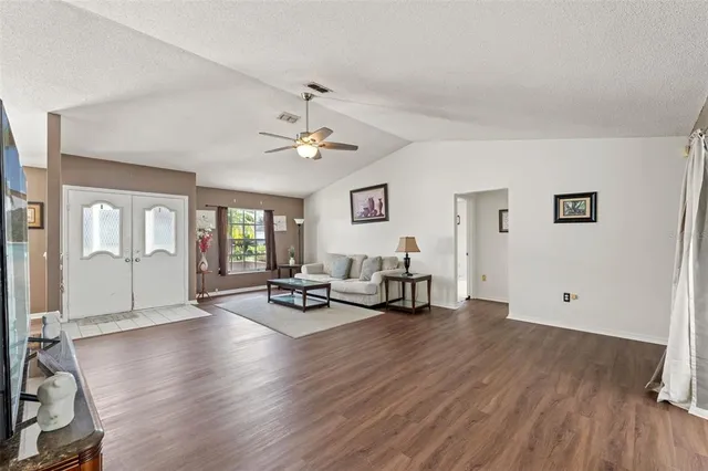 a view of a livingroom with furniture and hardwood floor