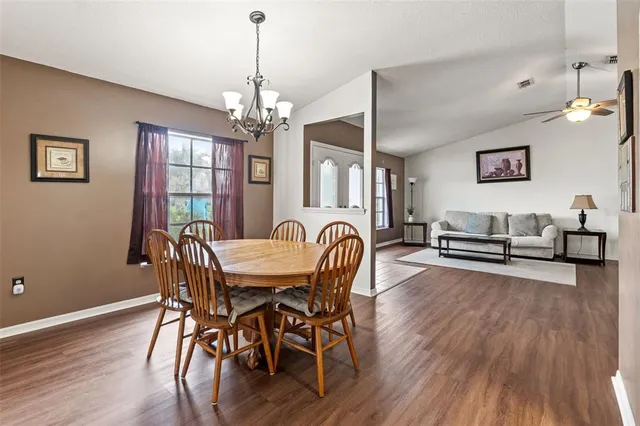 a view of a a dining room with furniture window and wooden floor