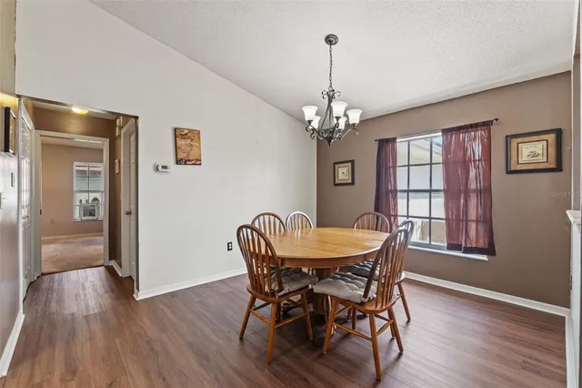 a view of a dining room with furniture wooden floor and chandelier