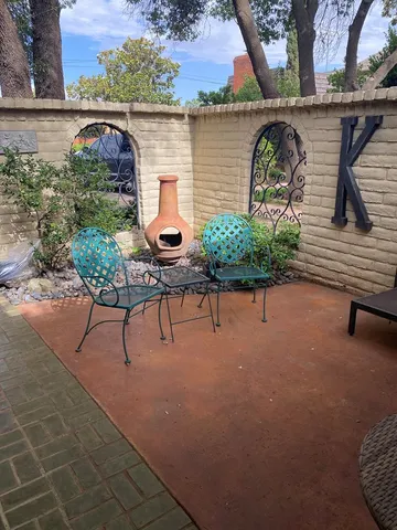 a backyard of a house with outdoor seating