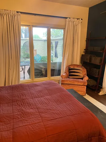 a bedroom with a bed and a large window