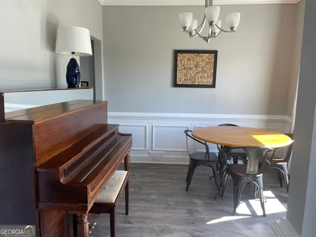 a view of a dining room with furniture and a chandelier