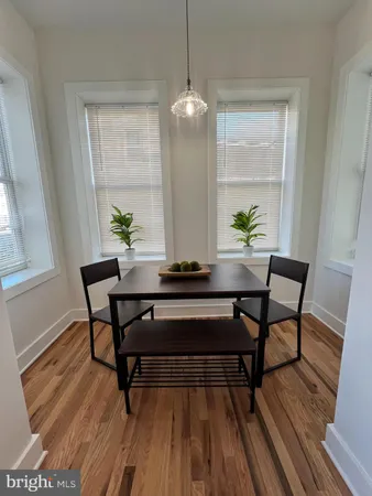 a living room with a table and a potted plant