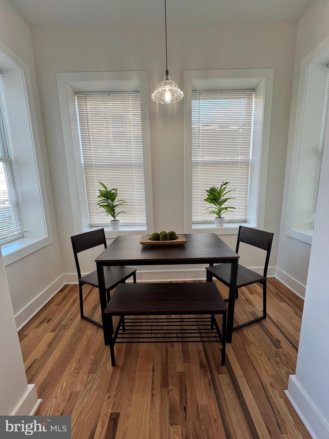 106 East Broad Street, Unit 2 Burlington, NJ 08016 - Photo 3 of 13 a living room with a table and a potted plant
