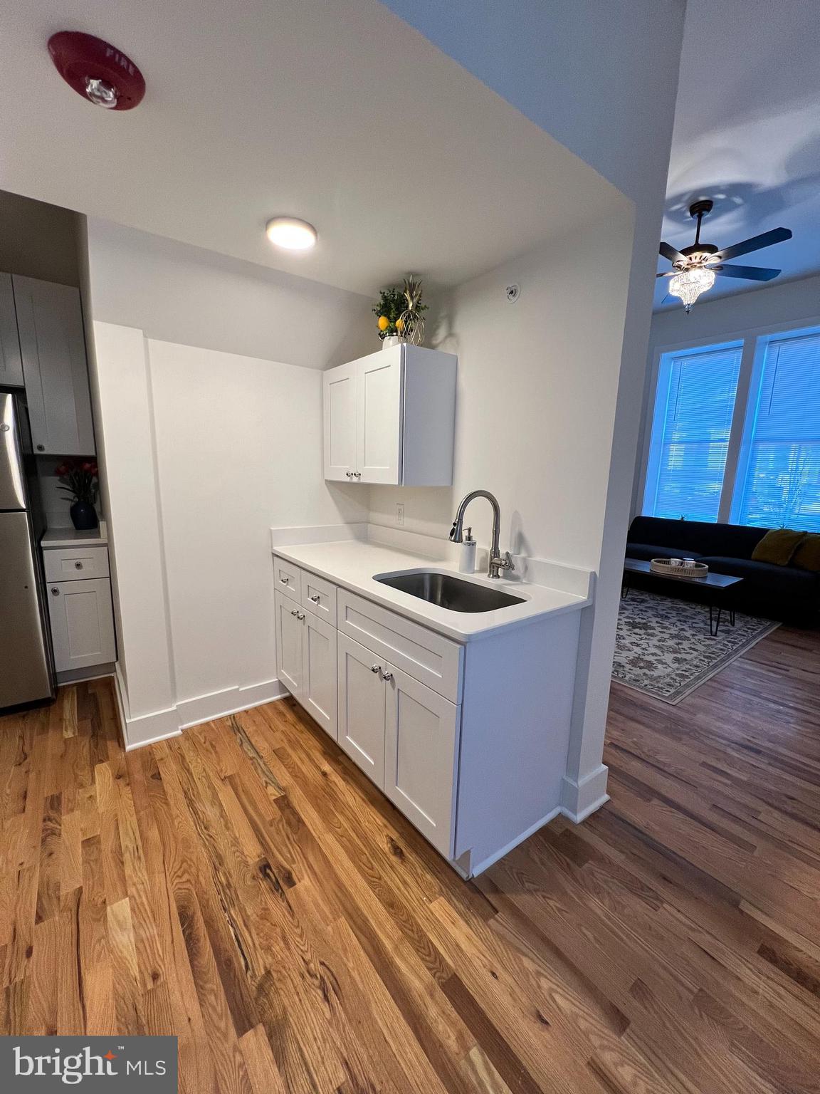 106 East Broad Street, Unit 2 Burlington, NJ 08016 - Photo 5 of 13 a kitchen with wooden floors appliances and cabinets