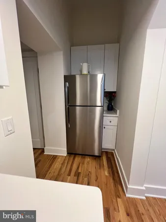 a white refrigerator freezer sitting inside of a kitchen