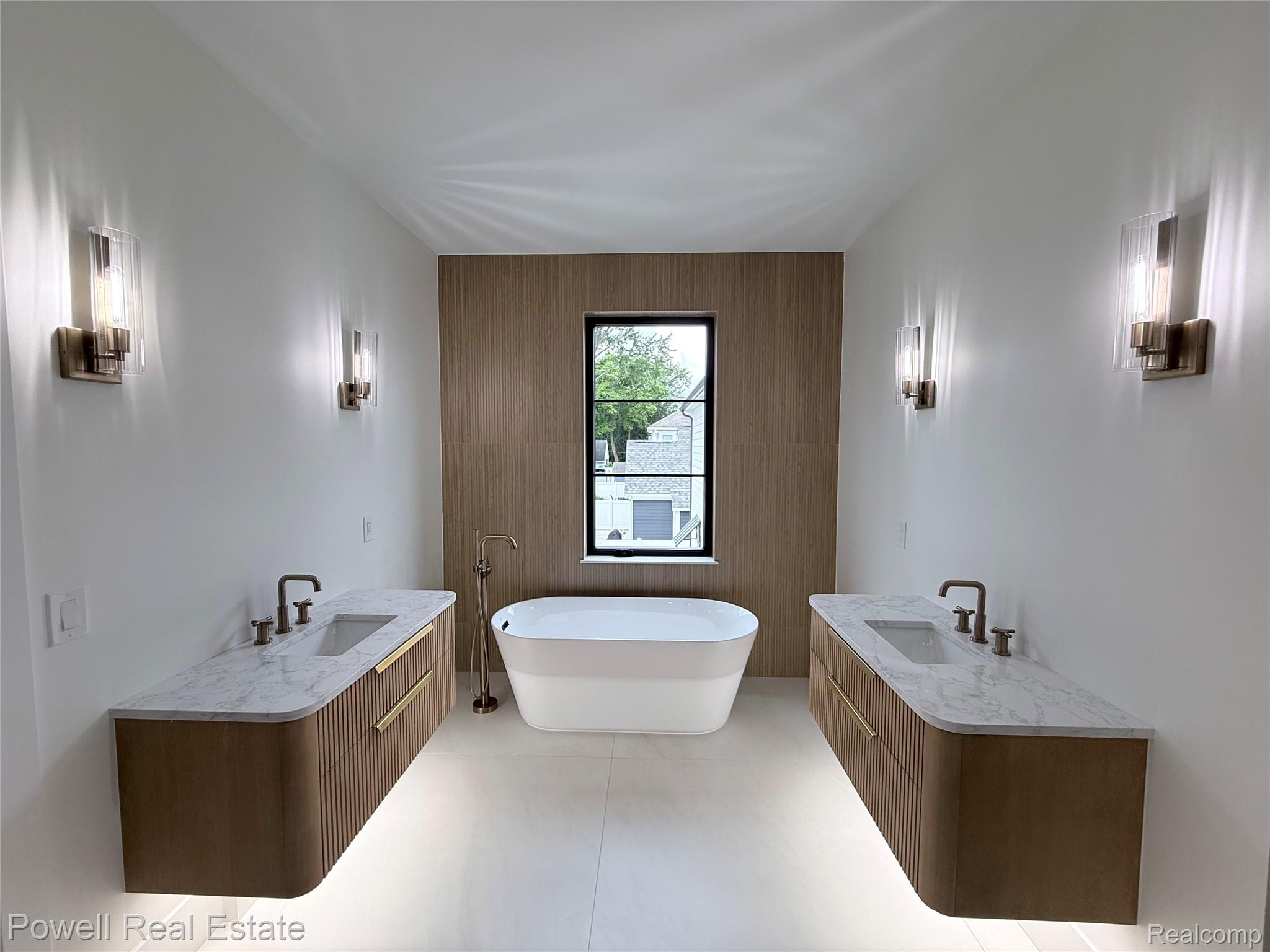 1998 Hazel Street Birmingham, MI 48009 - Photo 15 of 22 Modern bathroom featuring a freestanding soaking tub centered beneath a window