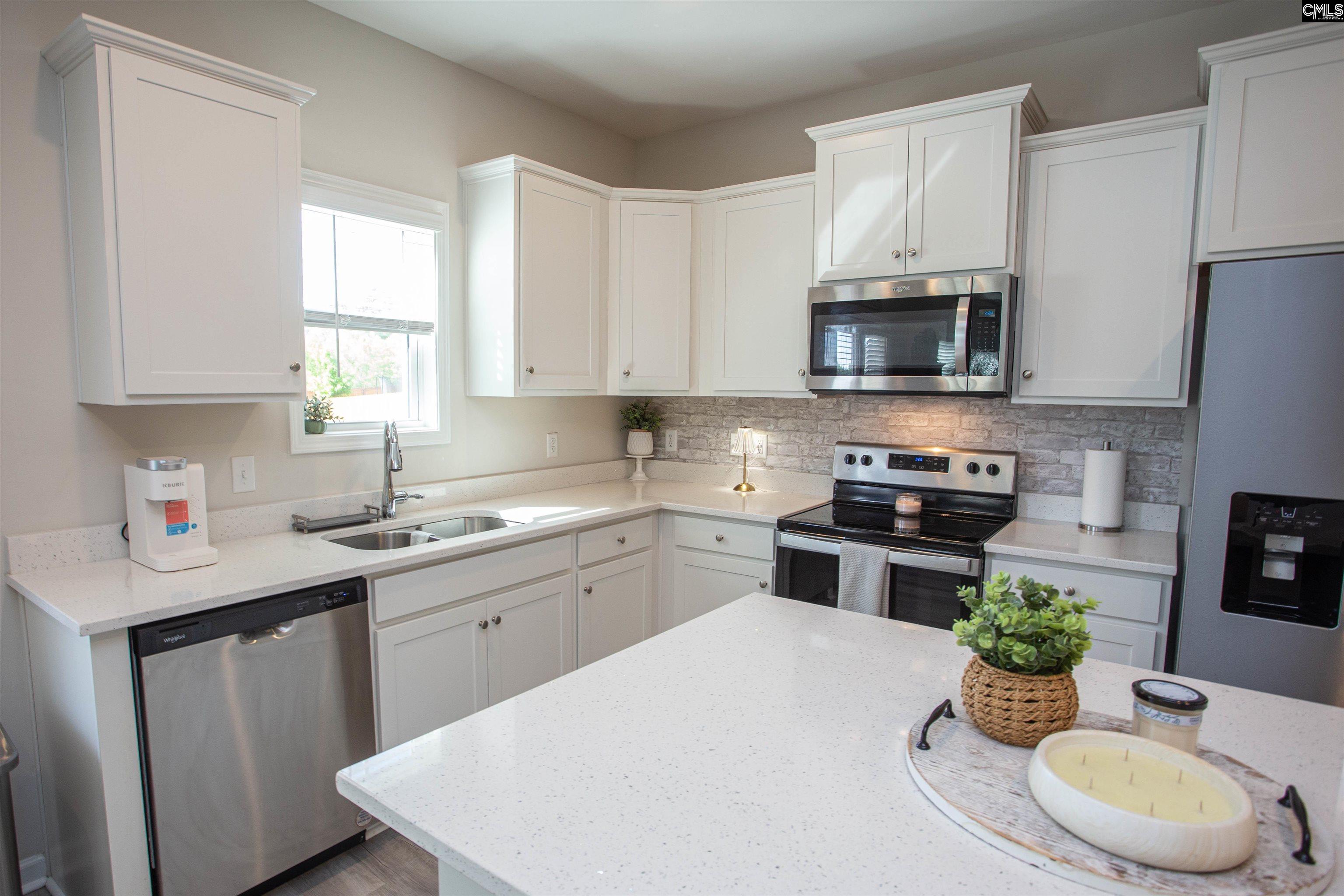 272 Shadowbrook Way Camden, SC 29020 - Photo 11 of 43 a kitchen with stainless steel appliances white cabinets a sink and a stove