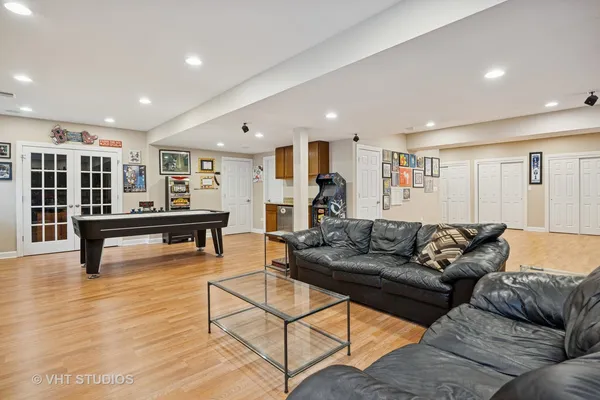 a room with furniture pool table and windows