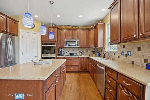 a kitchen with stainless steel appliances granite countertop a sink stove and cabinets
