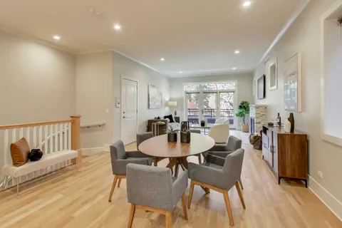 a dining room with furniture and wooden floor