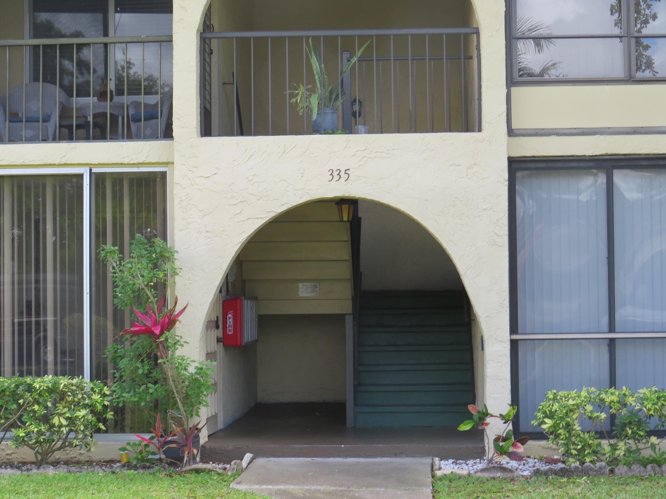 a front view of a house with plants