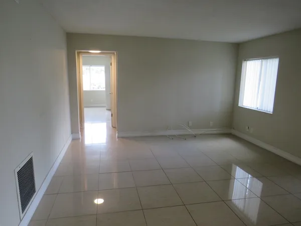 an empty room with windows and entrance