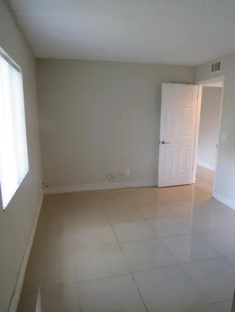 a view of an empty room and a window