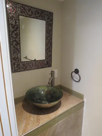 a view of bathroom with a sink and mirror