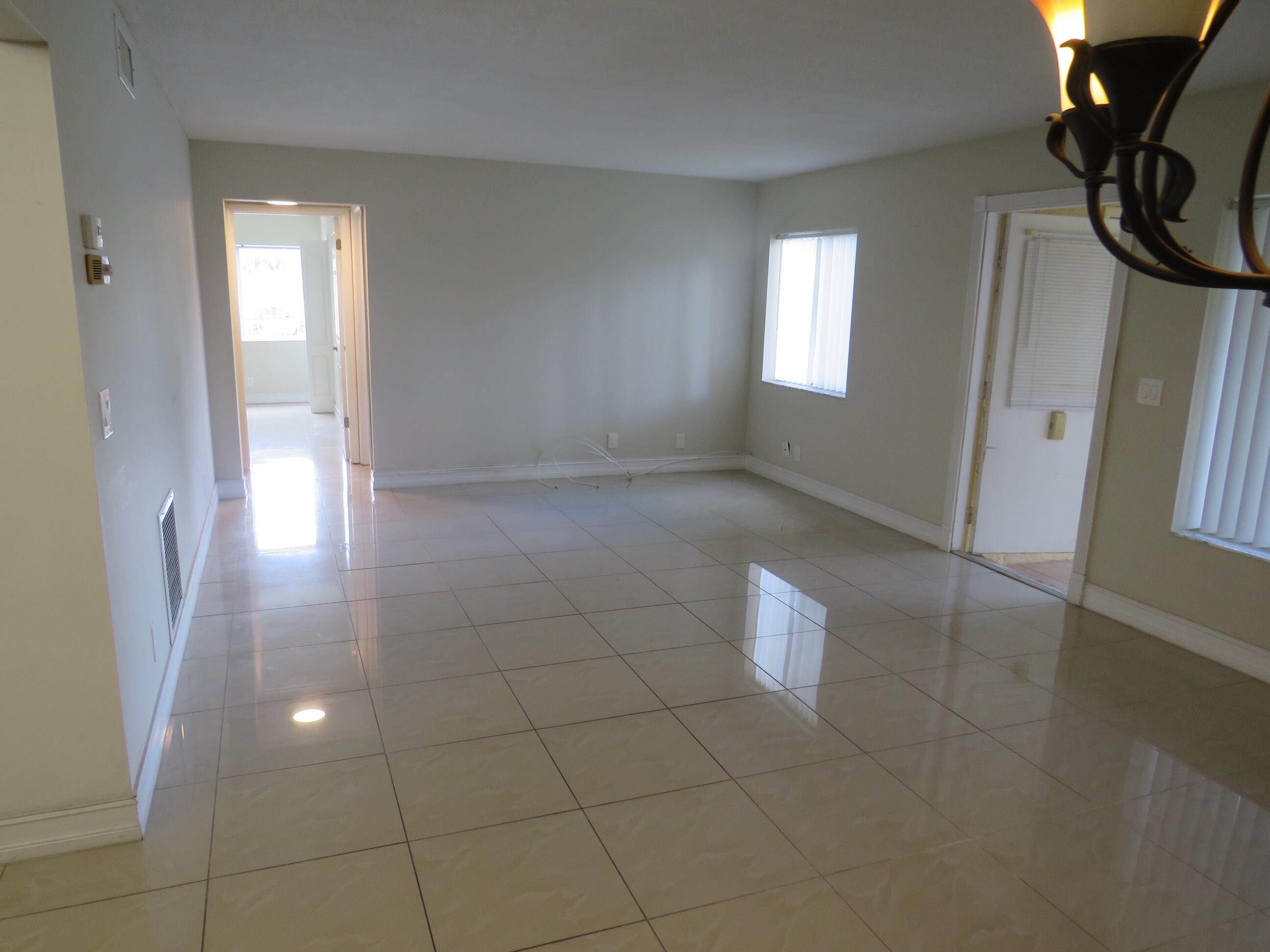 335 Pine Ridge Circle, Unit D1 Greenacres, FL 33463 - Photo 25 of 30 a view of an empty room with a bathroom and a window