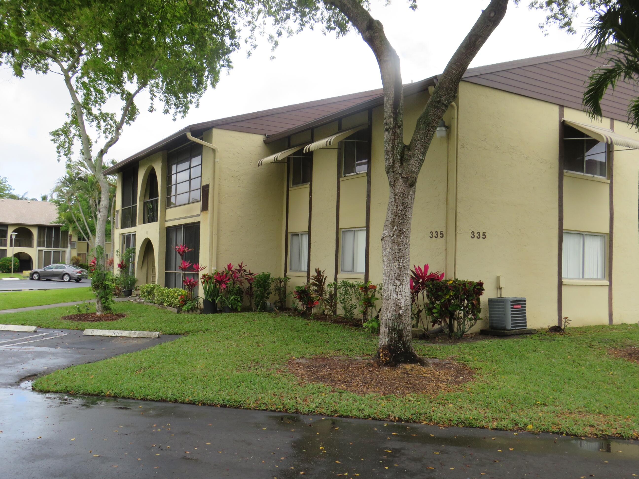 335 Pine Ridge Circle, Unit D1 Greenacres, FL 33463 - Photo 29 of 30 a front view of house with yard