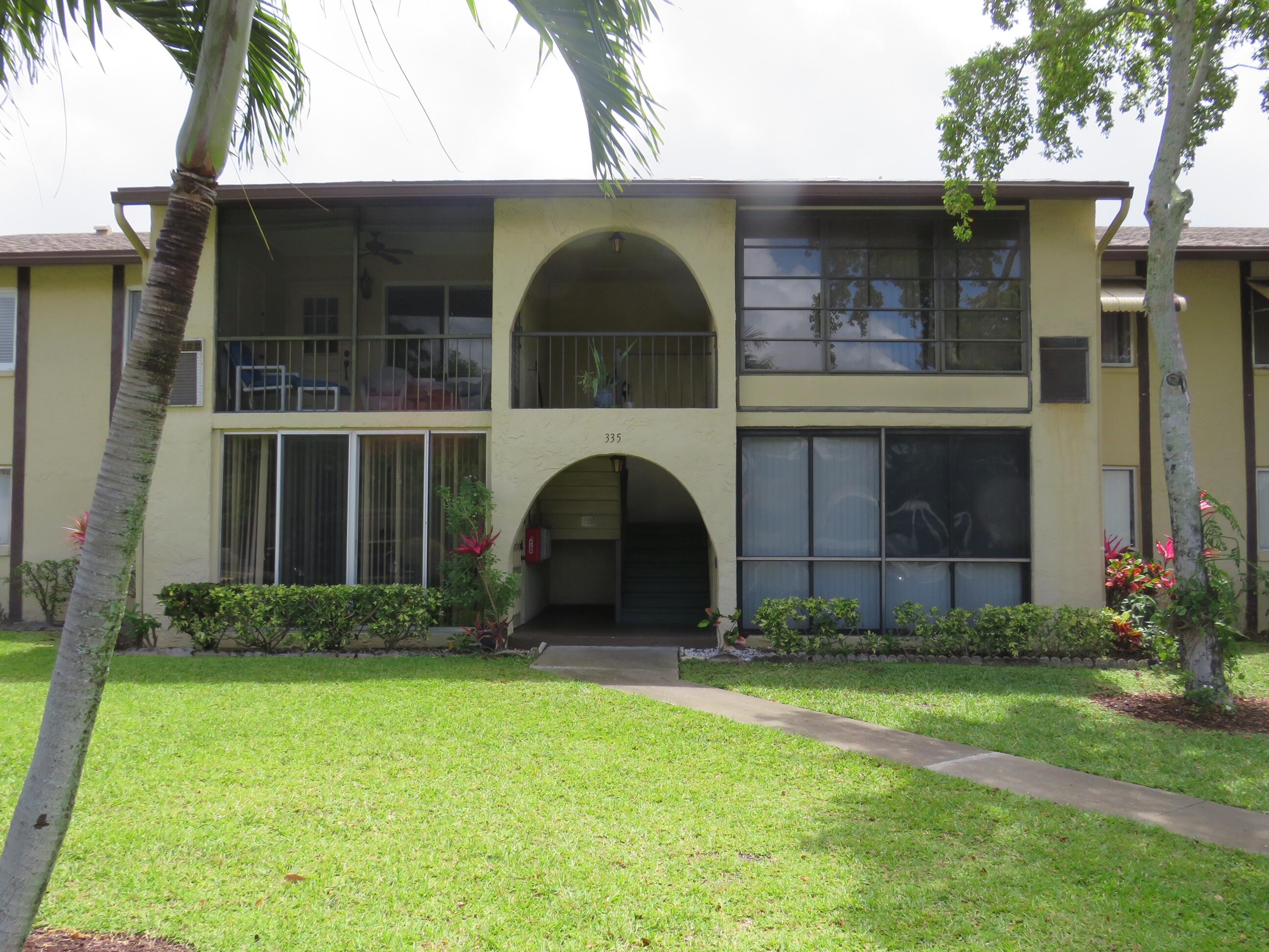 335 Pine Ridge Circle, Unit D1 Greenacres, FL 33463 - Photo 30 of 30 a view of a yard in front of a house with a large tree