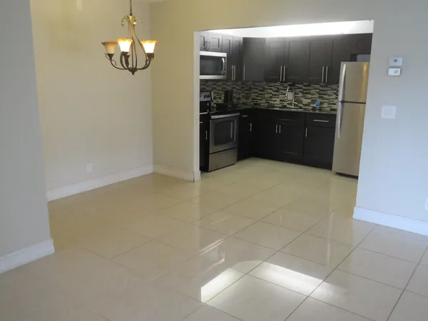 a large kitchen with a stove and a refrigerator