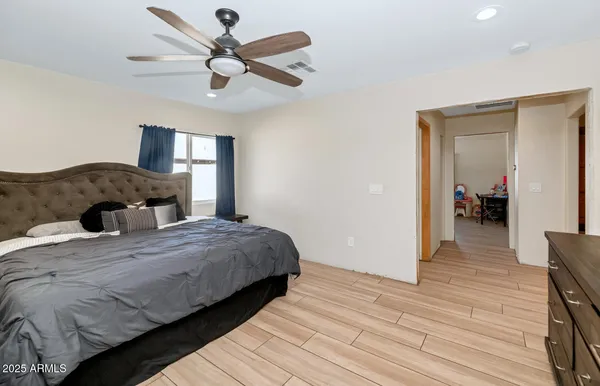 a bedroom with a bed and a chandelier