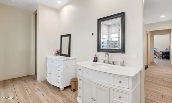 a bathroom with a sink vanity and mirror