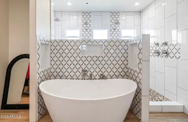 a bathroom with a bathtub and a shower