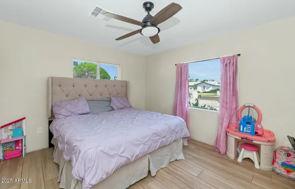 a bedroom with a bed and a chandelier