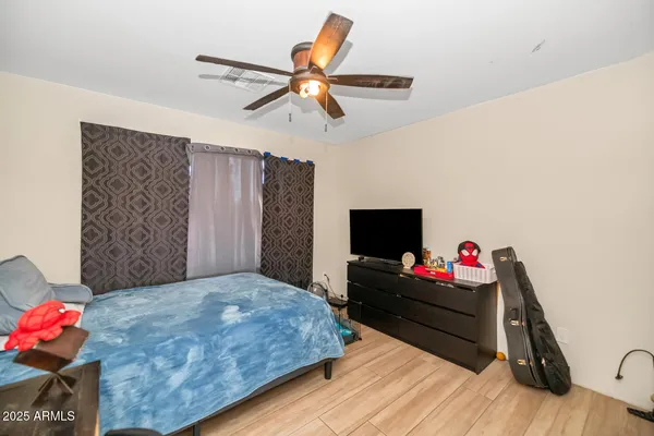 a bedroom with a bed and a chandelier