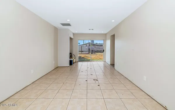 a view of a hallway with closet and a window