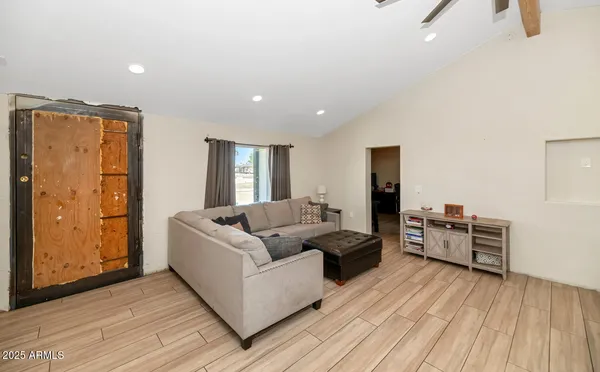 a living room with furniture and wooden floor