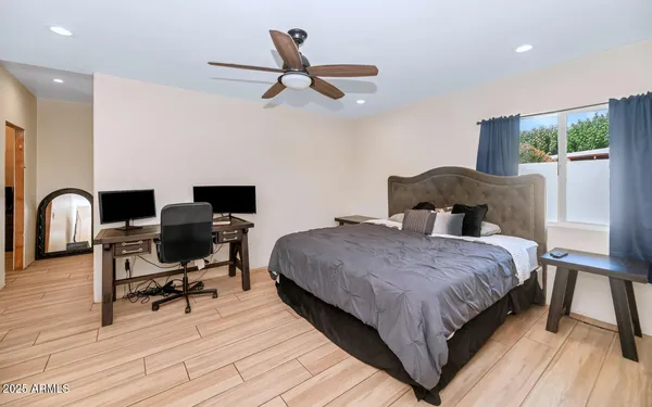 a bedroom with a bed and a desk