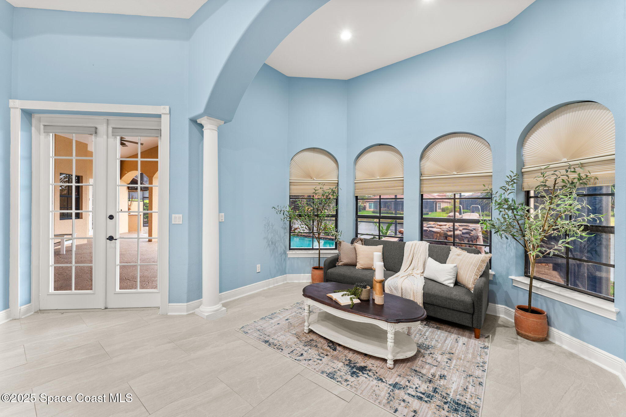 6205 Anello Drive Melbourne, FL 32940 - Photo 17 of 49 a living room with furniture fireplace and floor to ceiling window