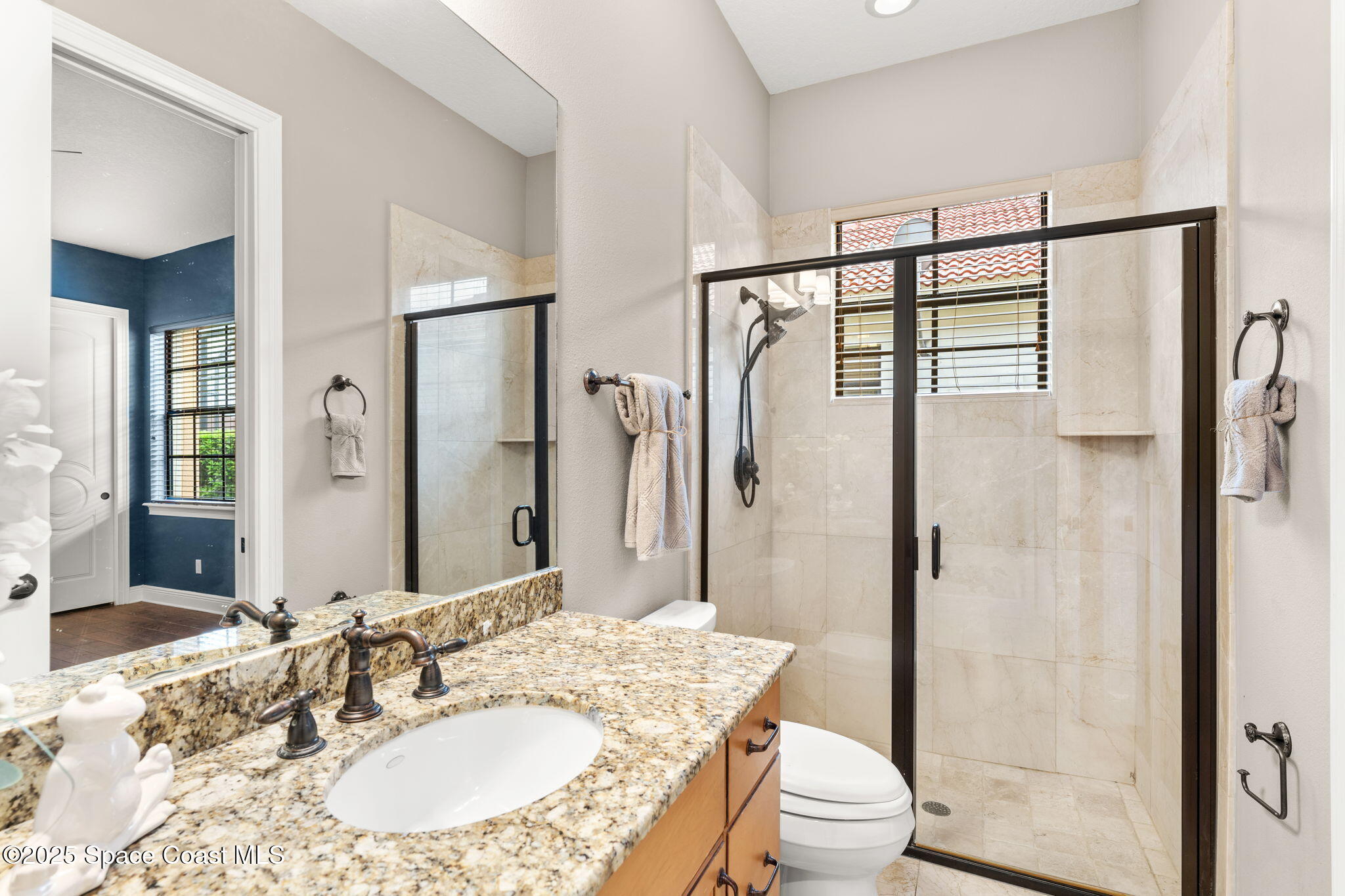 6205 Anello Drive Melbourne, FL 32940 - Photo 23 of 49 a bathroom with a granite countertop sink toilet and shower