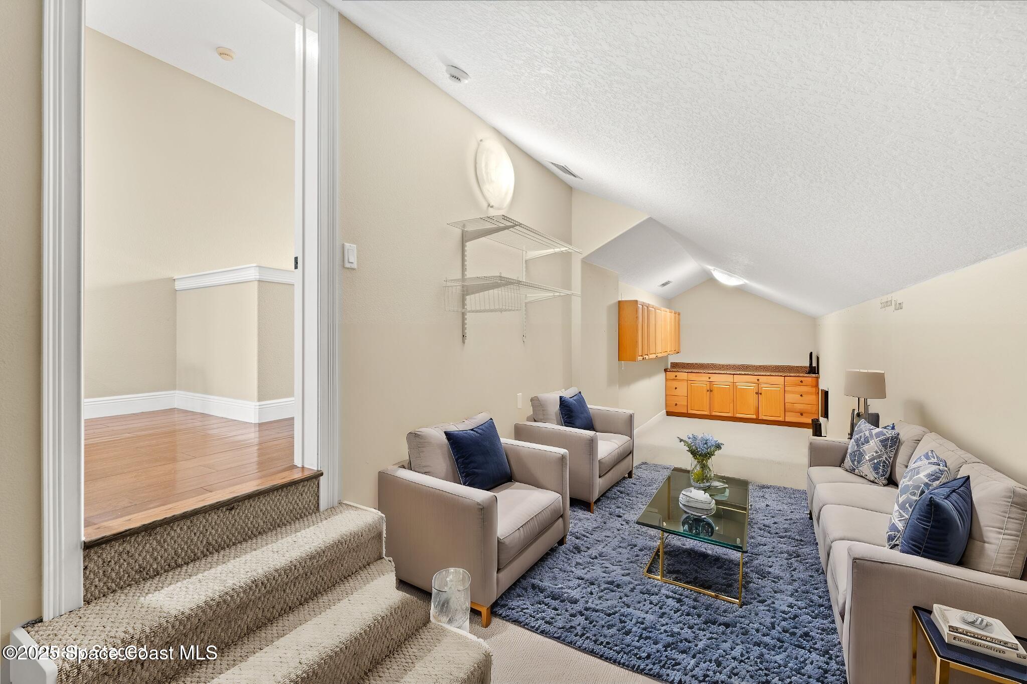 6205 Anello Drive Melbourne, FL 32940 - Photo 25 of 49 a living room with furniture and a large window