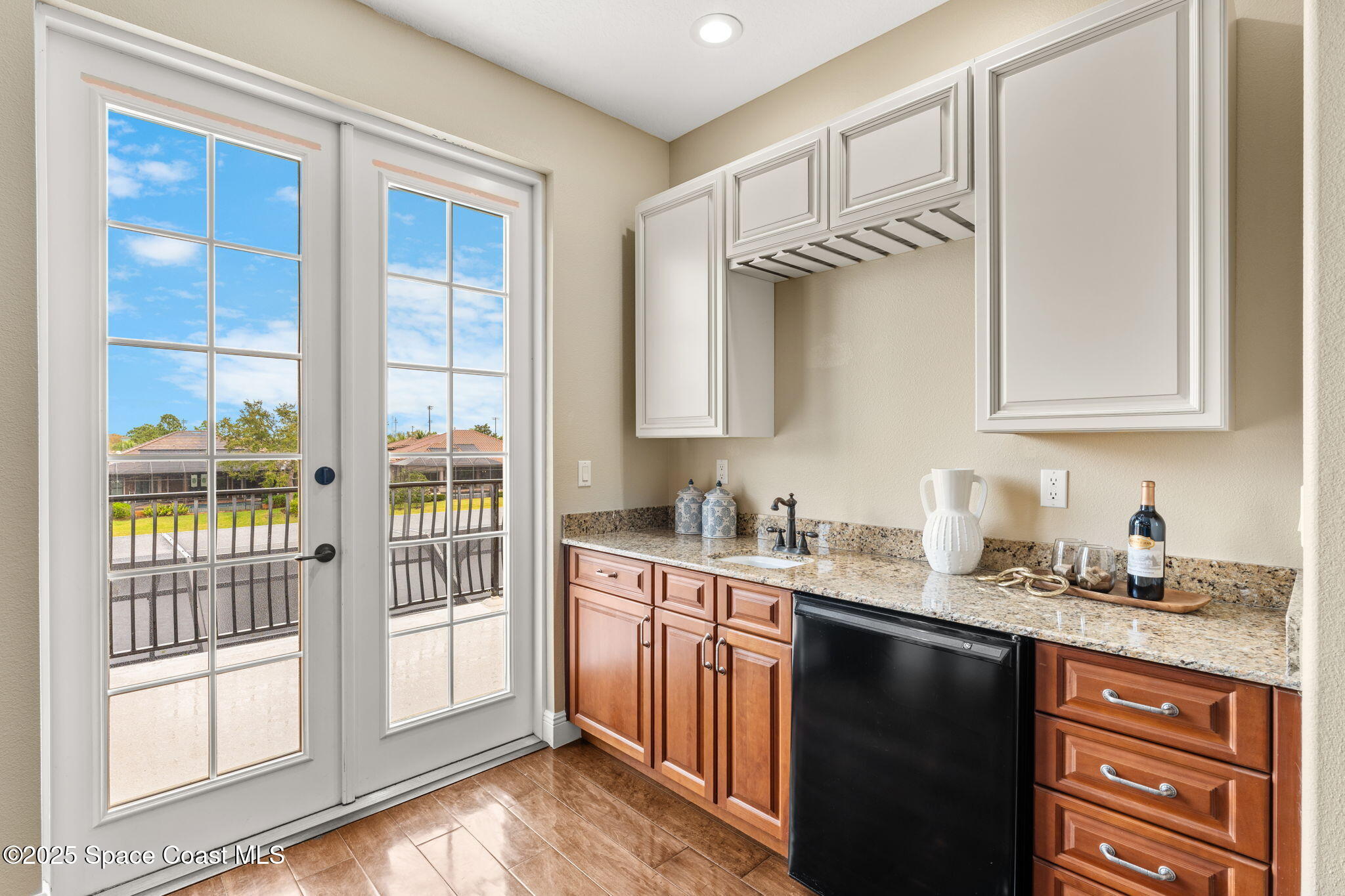 6205 Anello Drive Melbourne, FL 32940 - Photo 29 of 49 a kitchen with stainless steel appliances granite countertop a sink stove and cabinets