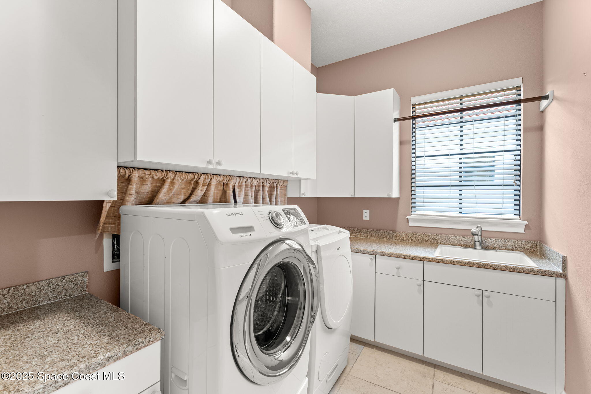6205 Anello Drive Melbourne, FL 32940 - Photo 37 of 49 a utility room with sink dryer and washer