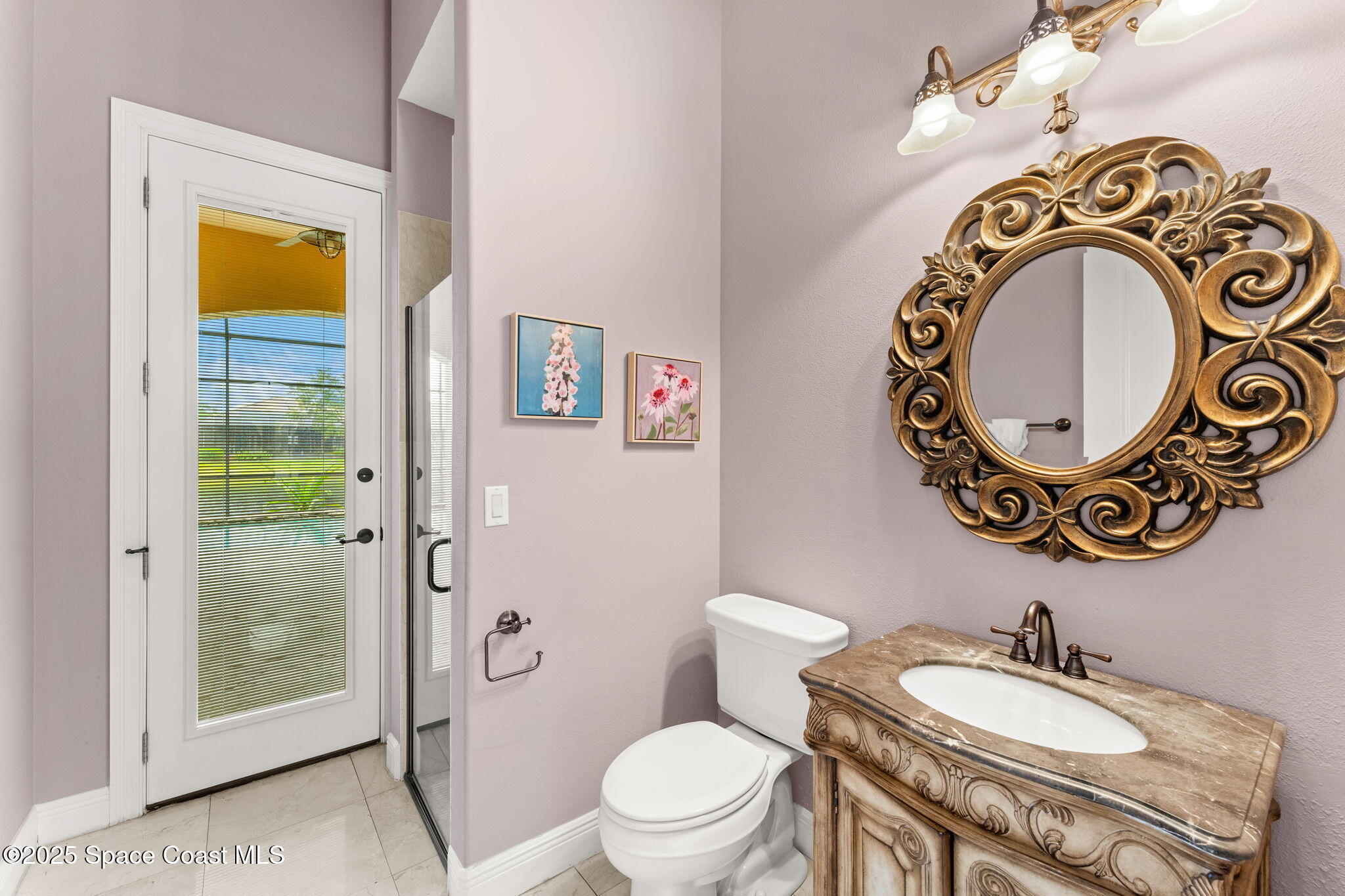 6205 Anello Drive Melbourne, FL 32940 - Photo 38 of 49 a bathroom with a toilet a sink and a mirror