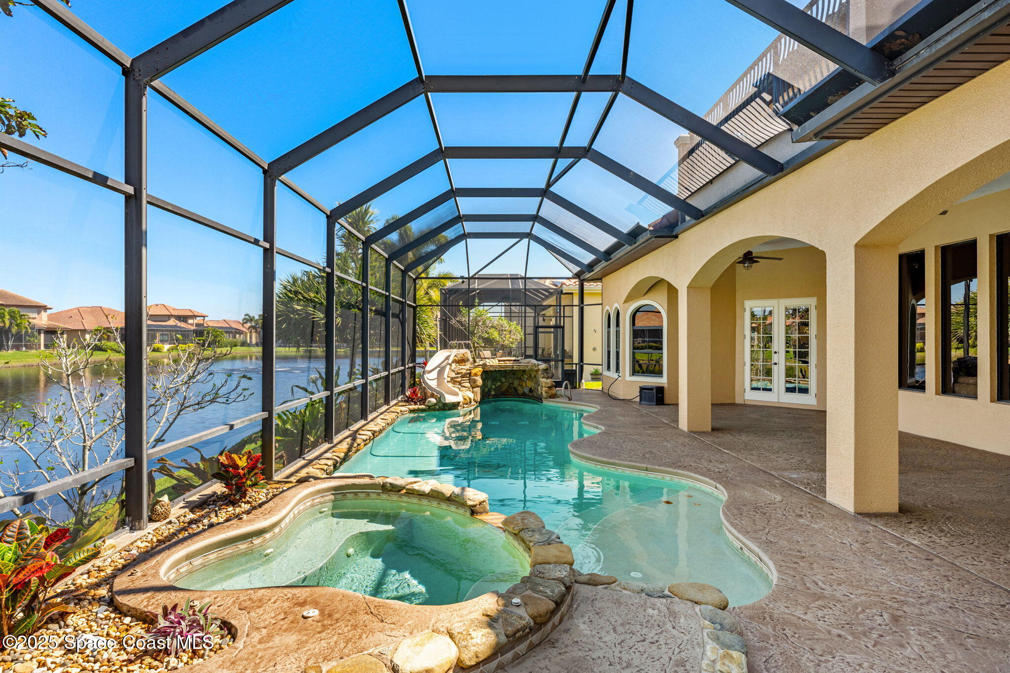 6205 Anello Drive Melbourne, FL 32940 - Photo 39 of 49 a swimming pool with lawn chairs and a umbrella