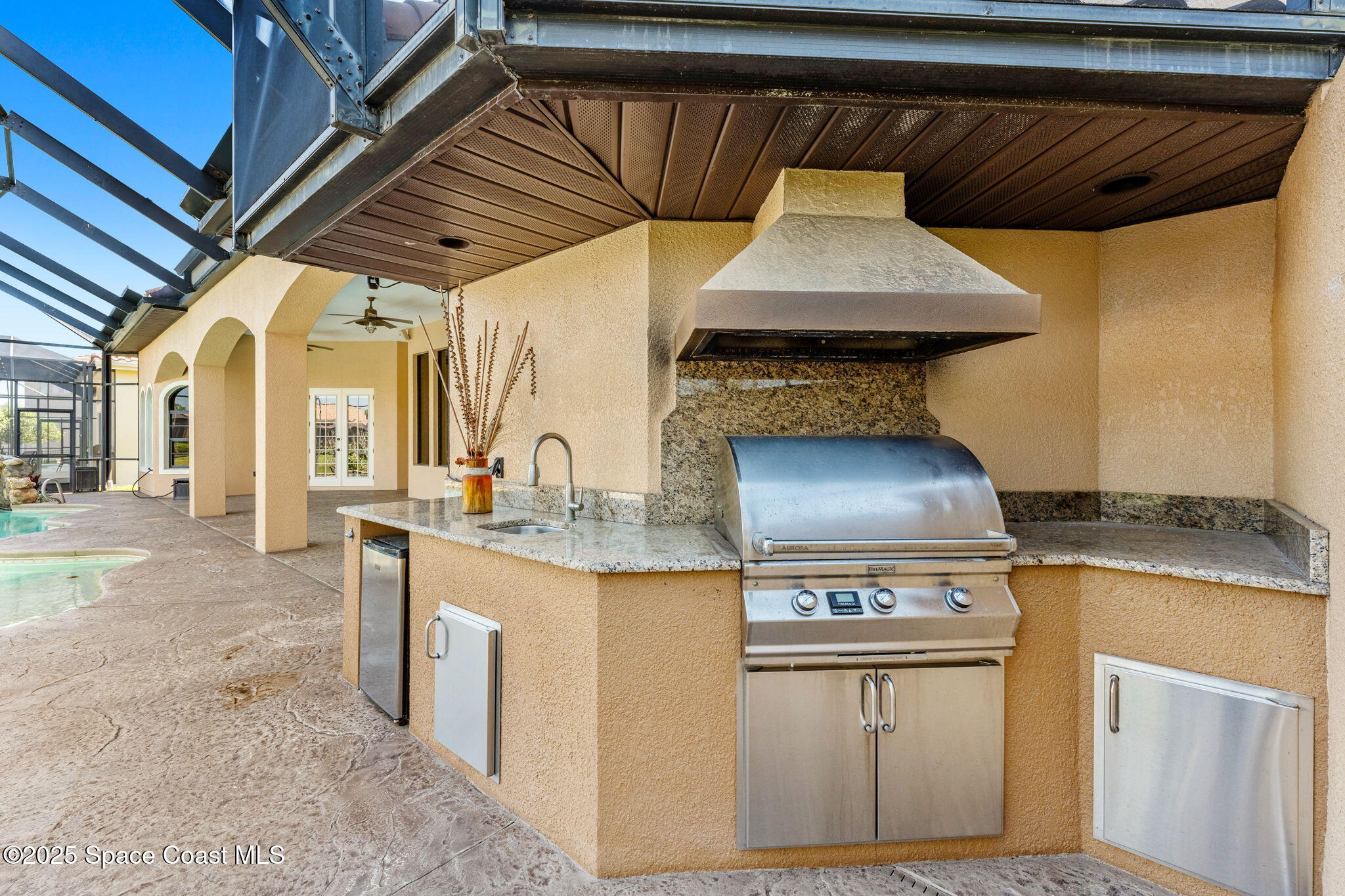 6205 Anello Drive Melbourne, FL 32940 - Photo 41 of 49 a kitchen with a stove and a white cabinets