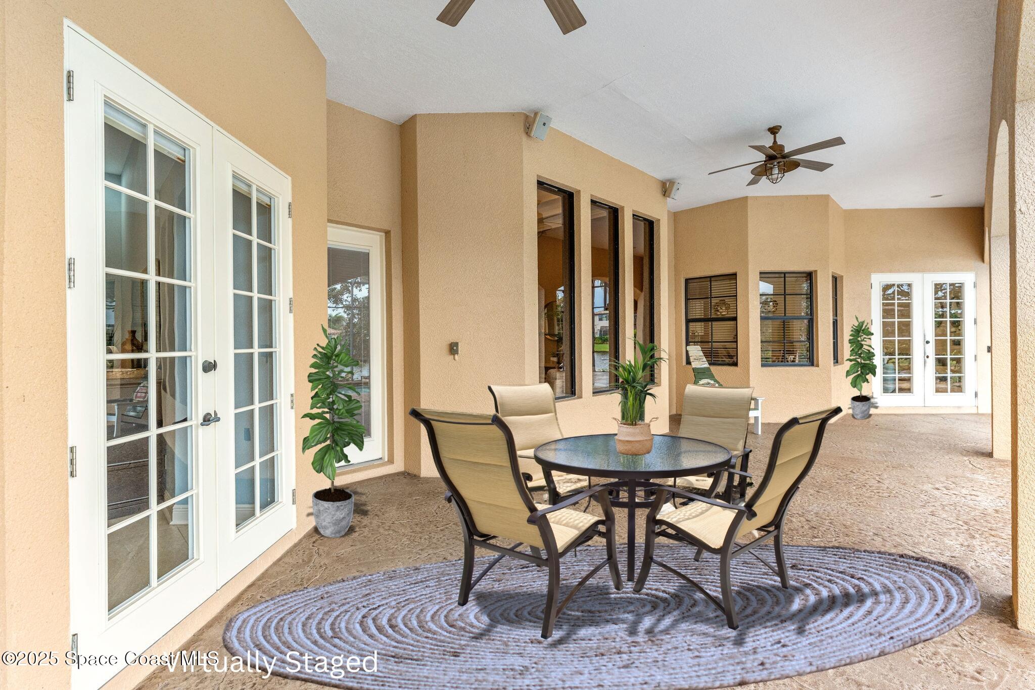 6205 Anello Drive Melbourne, FL 32940 - Photo 44 of 49 a dining room with furniture a chandelier and wooden floor