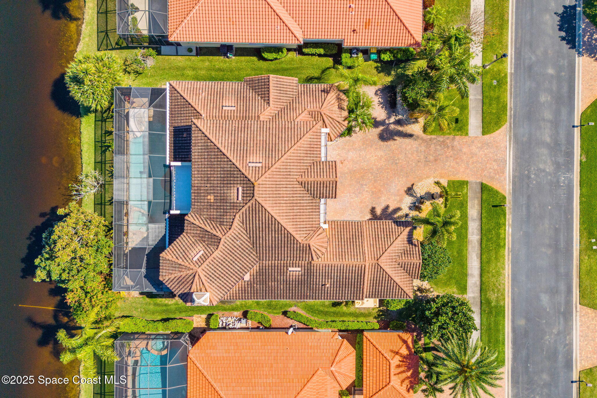 6205 Anello Drive Melbourne, FL 32940 - Photo 48 of 49 an aerial view of a house with a garden and swimming pool