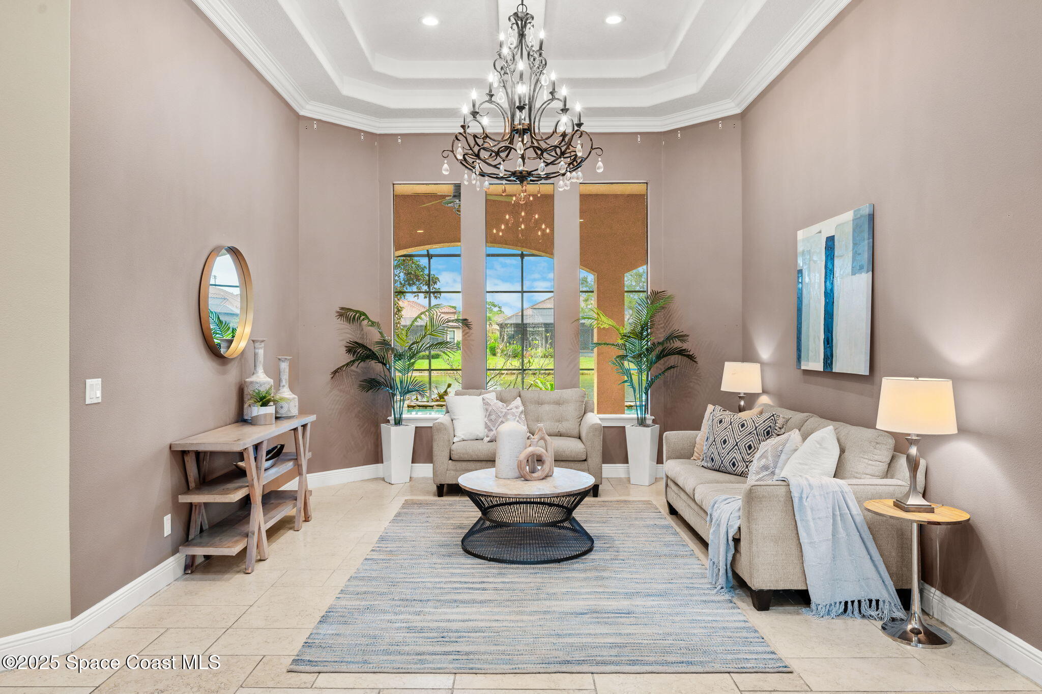 6205 Anello Drive Melbourne, FL 32940 - Photo 5 of 49 a living room with furniture and a chandelier