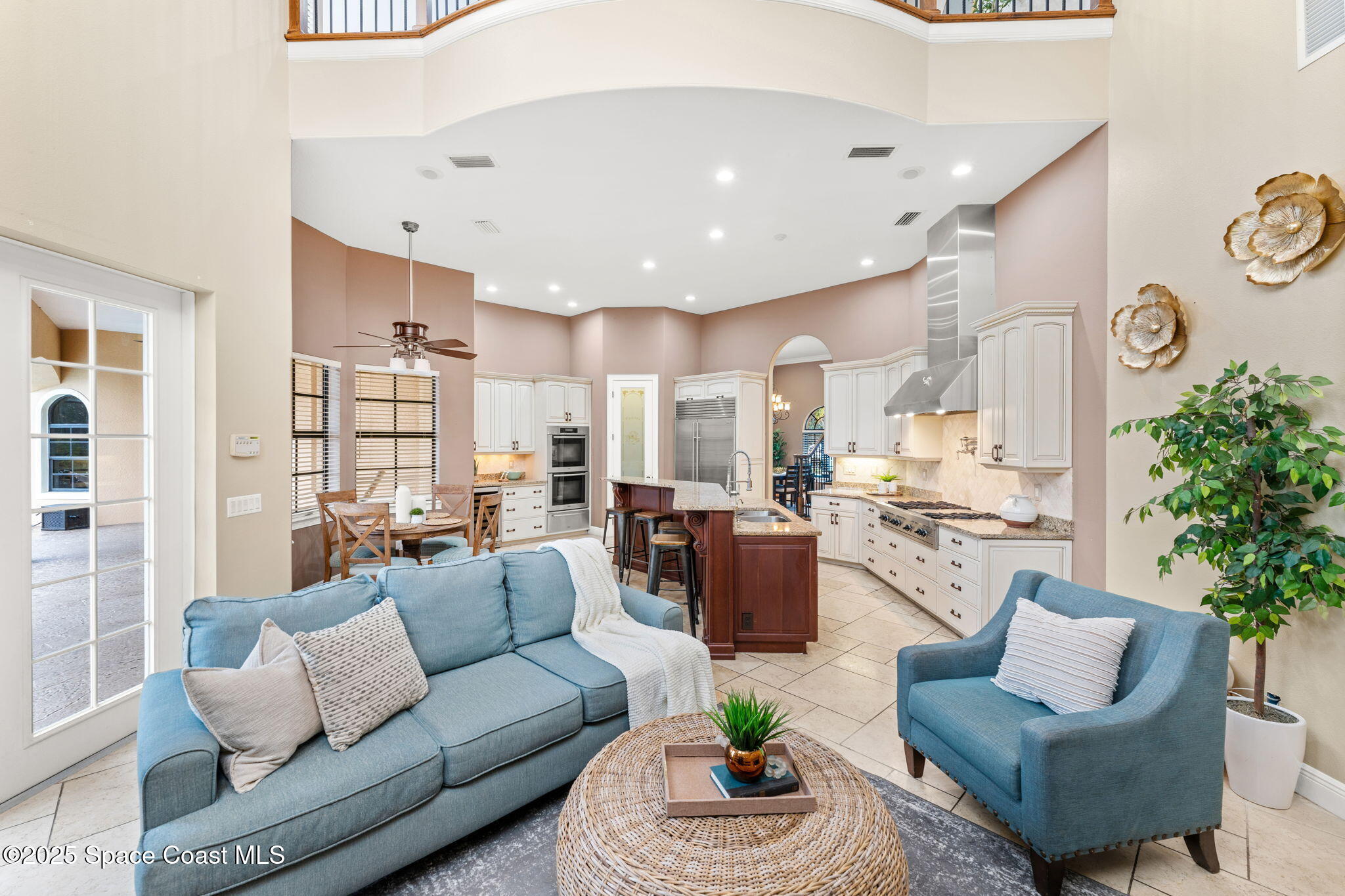 6205 Anello Drive Melbourne, FL 32940 - Photo 8 of 49 a living room with furniture kitchen view and a potted plant