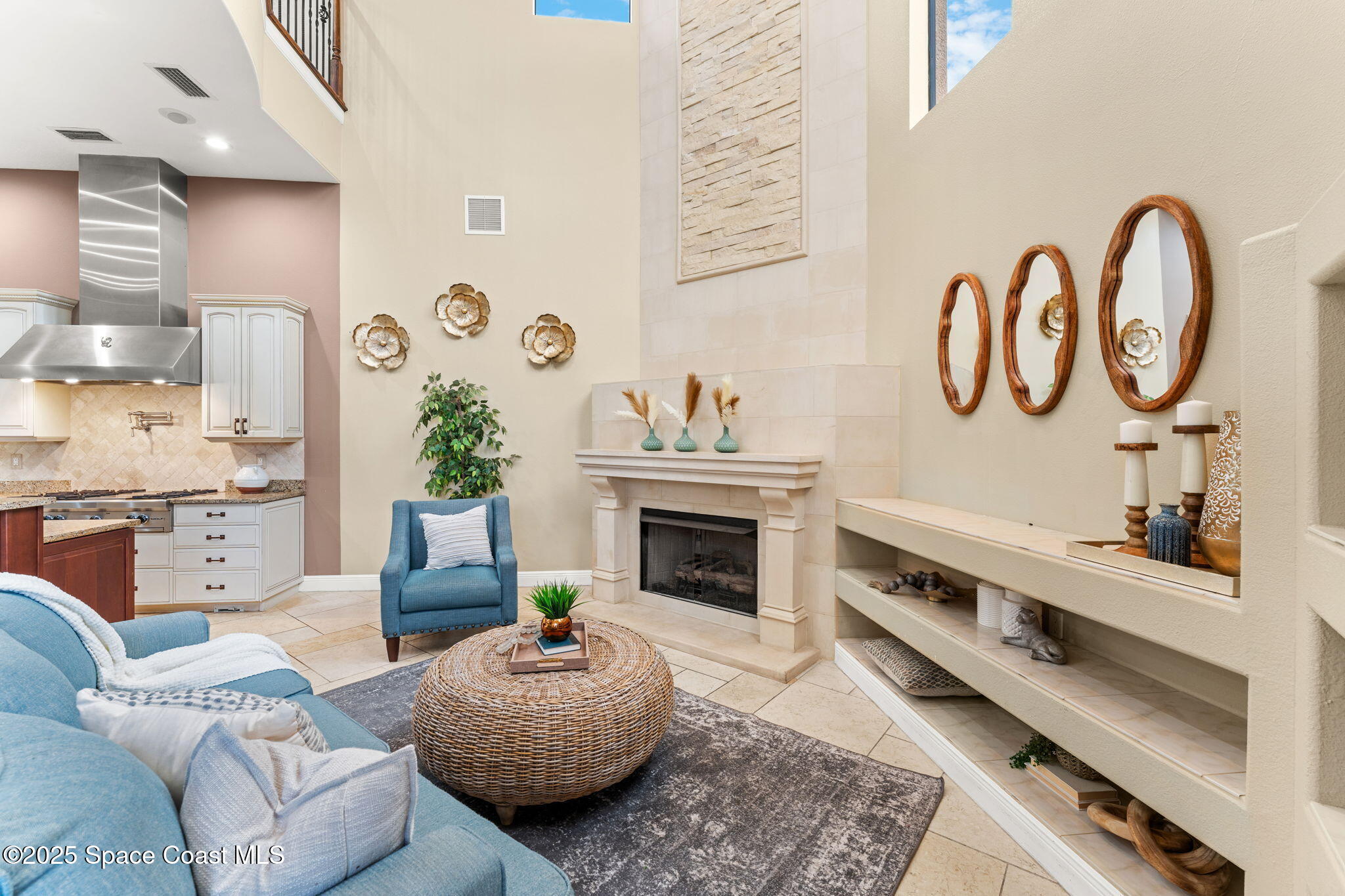 6205 Anello Drive Melbourne, FL 32940 - Photo 9 of 49 a living room with furniture a fireplace and kitchen view