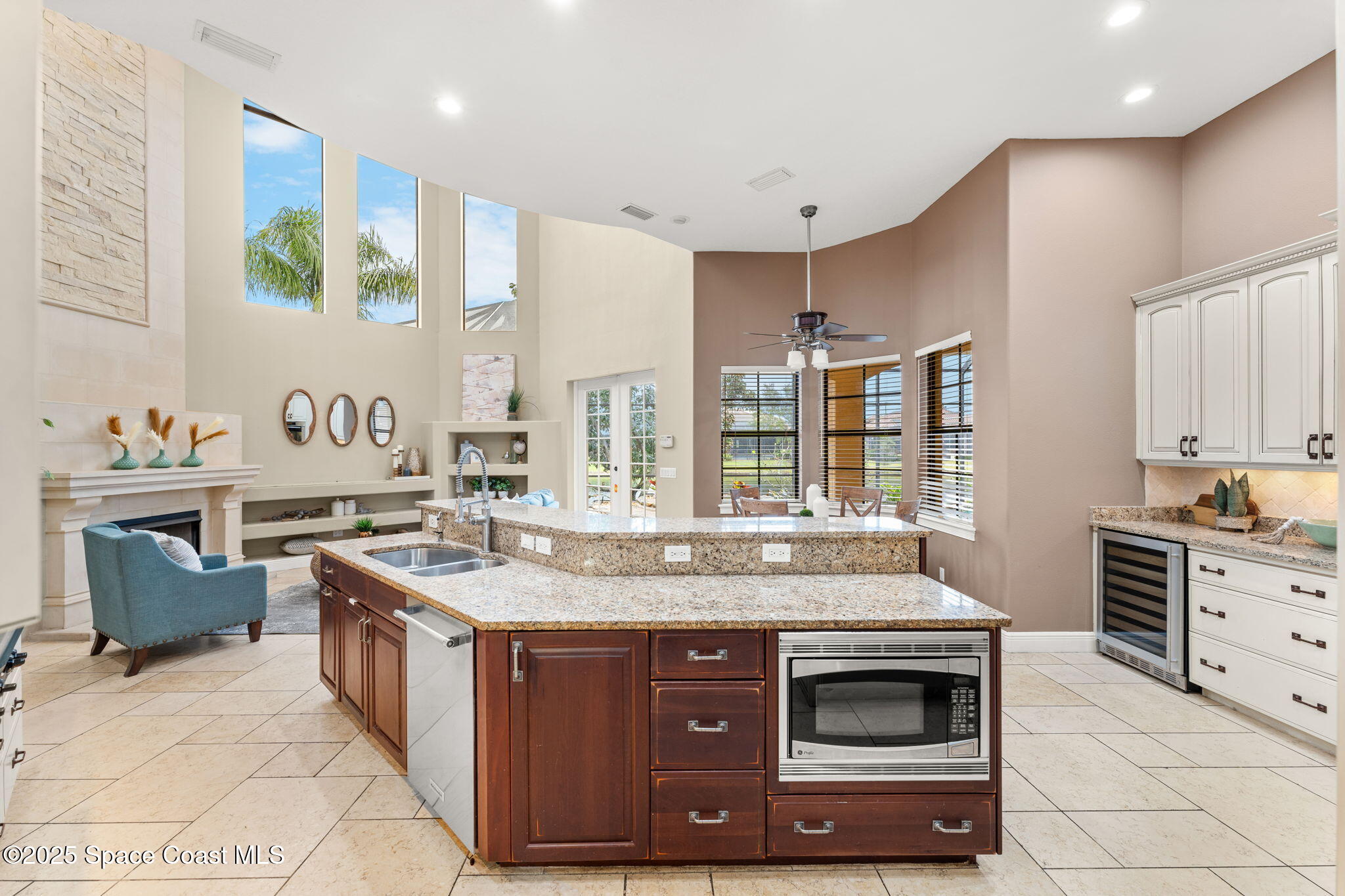 6205 Anello Drive Melbourne, FL 32940 - Photo 10 of 49 a kitchen with stainless steel appliances granite countertop a stove and a sink