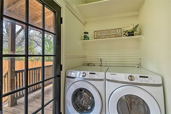 a view of a hallway with washer and dryer