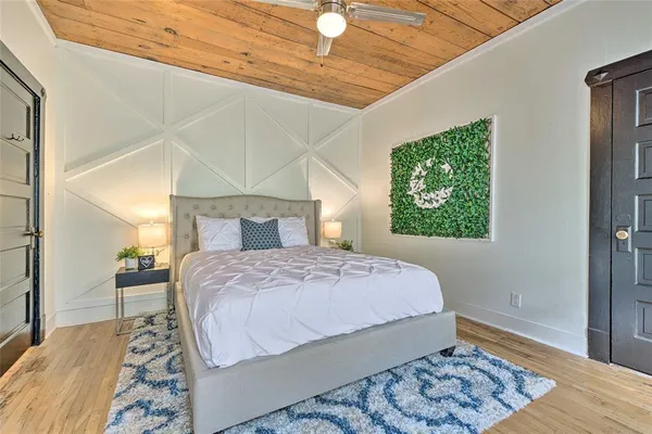 a bedroom with a bed and a window