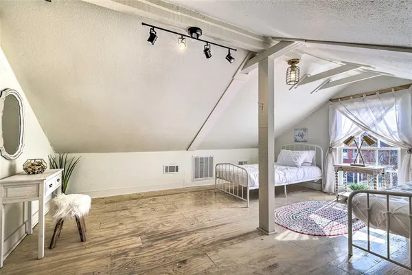 a bedroom with a bed and a large window